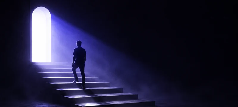 A dark hall, a glowing arched doorway and the silhouette of a person climbing the steps toward it